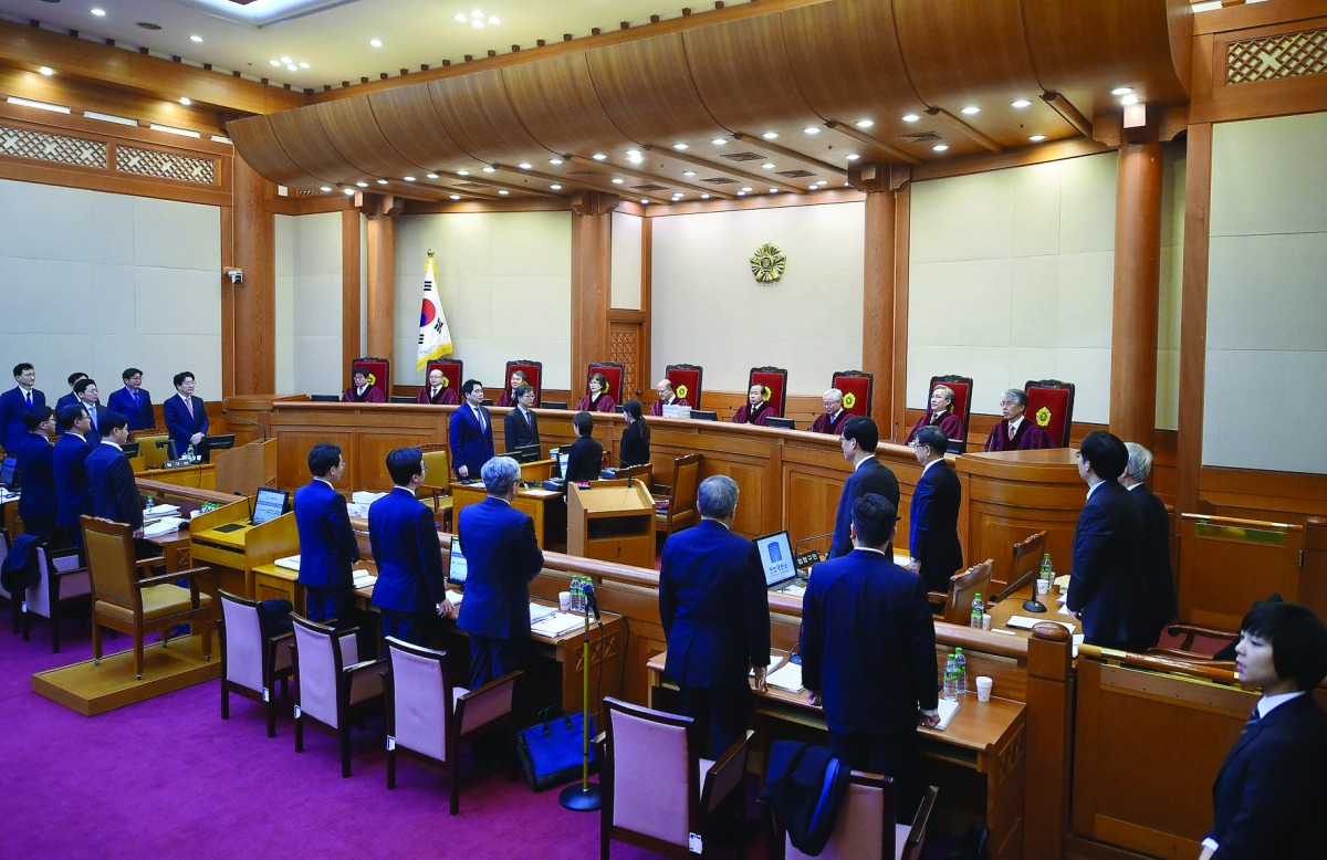 Nine judges of South Korea's Constitutional Court during a hearing on whether to confirm the impeachment of President Park Geun-hye, at the court in Seoul, yesterday.