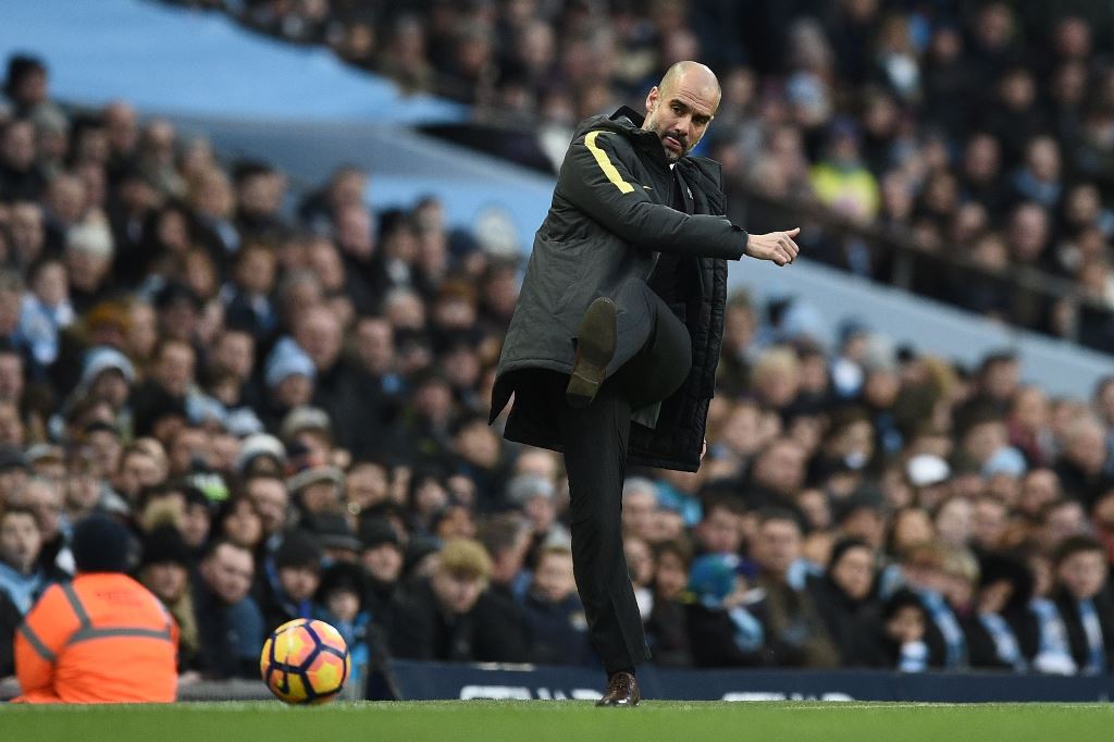 Manchester City's Spanish manager Pep Guardiola kicks the ball back onto the pitch during the English Premier League football match between Manchester City and Burnley at the Etihad Stadium in Manchester, north west England, on January 2, 2017. AFP / Oli 