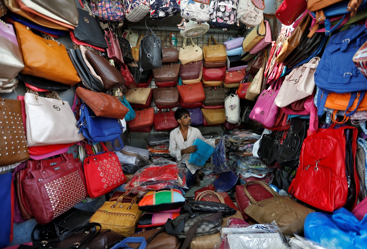 A vendor arranges bags as he waits for customers at his shop at a market in Mumbai, India, January 6, 2017. REUTERS/Danish Siddiqui
