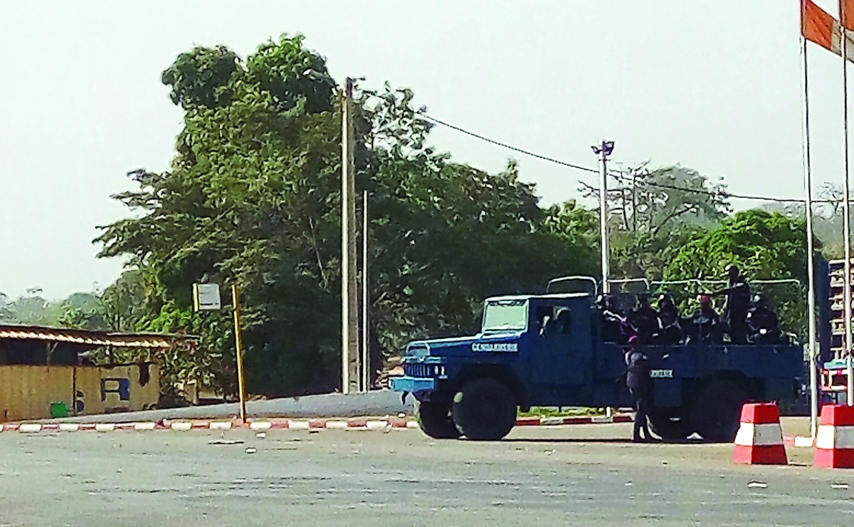 Ivorian armed police officers stand aboard a vehicle in a street of Bouake, yesterday.