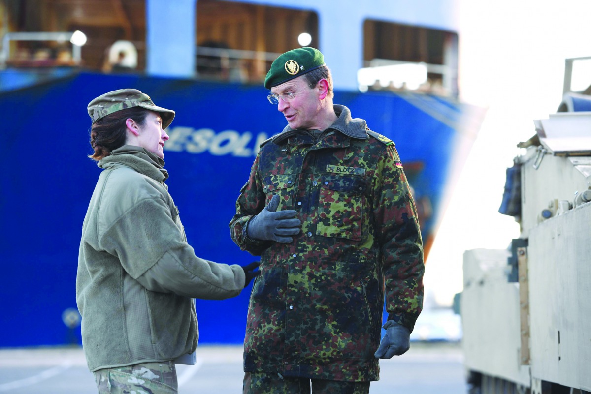 German Force commander General Major Josef Dieter Blotz (right) talks to a US military service personnel at the harbour in Bremerhaven, yesterday.