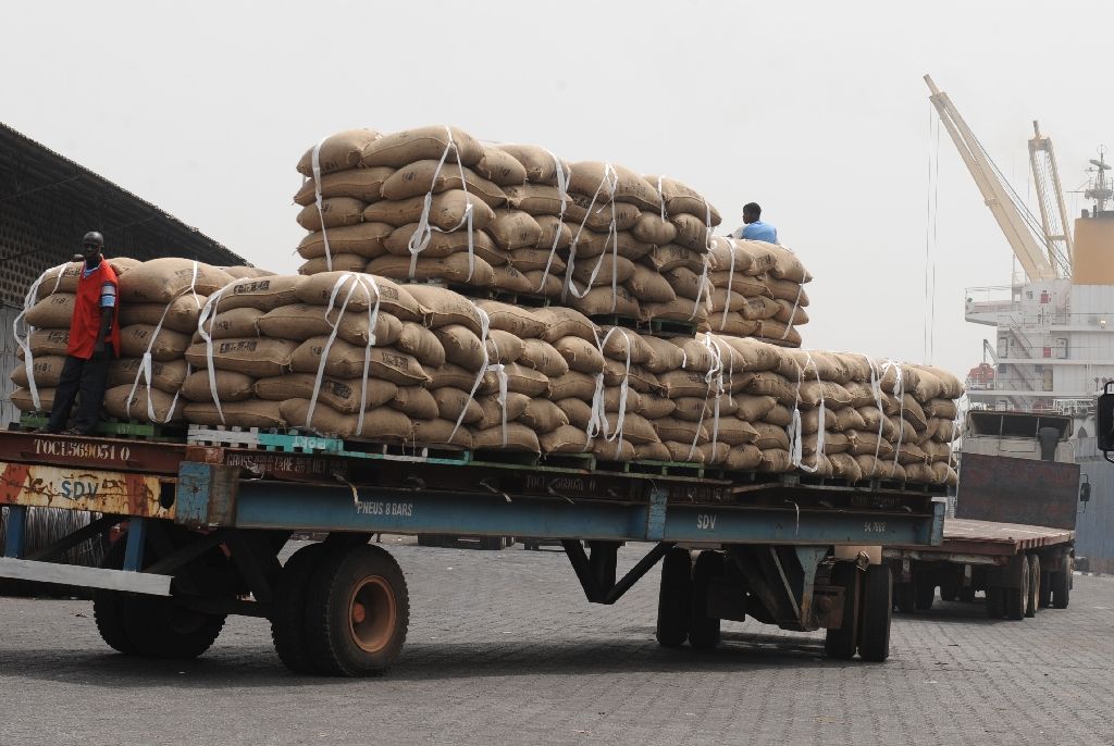 In January 2011, an Ivorian worker stands on a truck carrying bags of cocoa beans, 15 percent of Ivory Coast's GDP and more than 50 percent of its export earnings, according to the World Bank (AFP Photo/ISSOUF SANOGO)