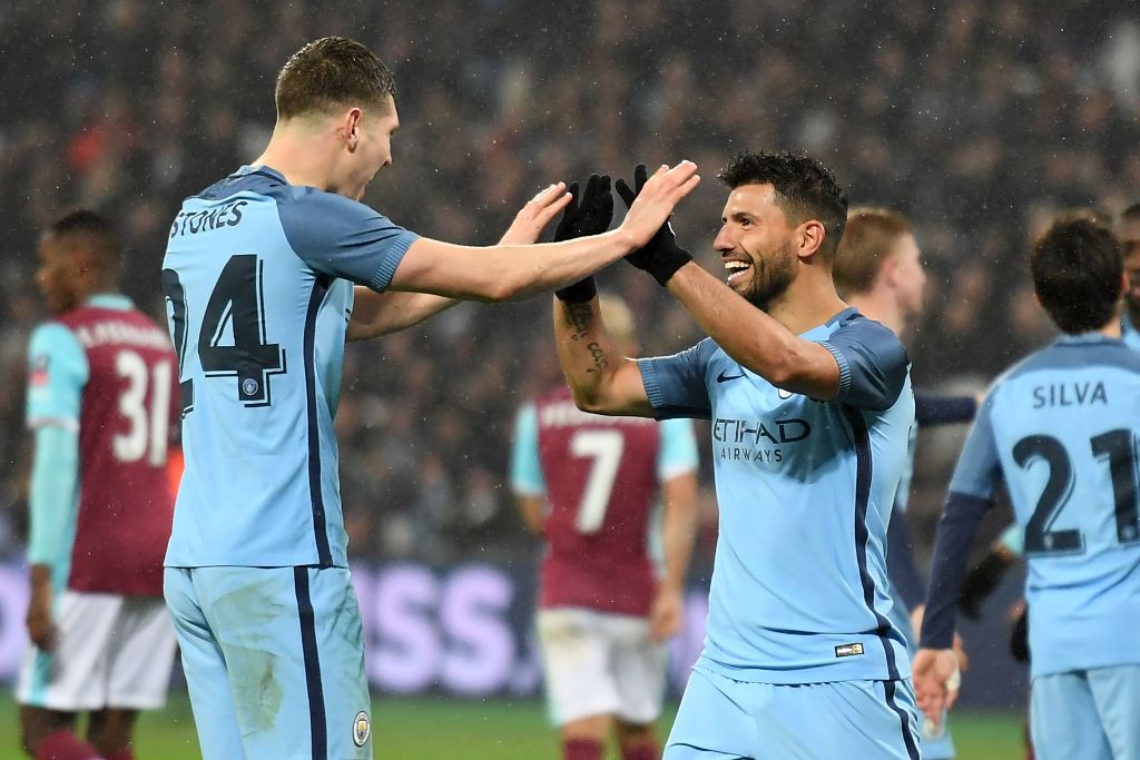 Manchester City's Argentinian striker Sergio Aguero (3rd R) celebrates with Manchester City's English defender John Stones after scoring their fourth goal during the English FA cup third round football match between West Ham United and Manchester City at 