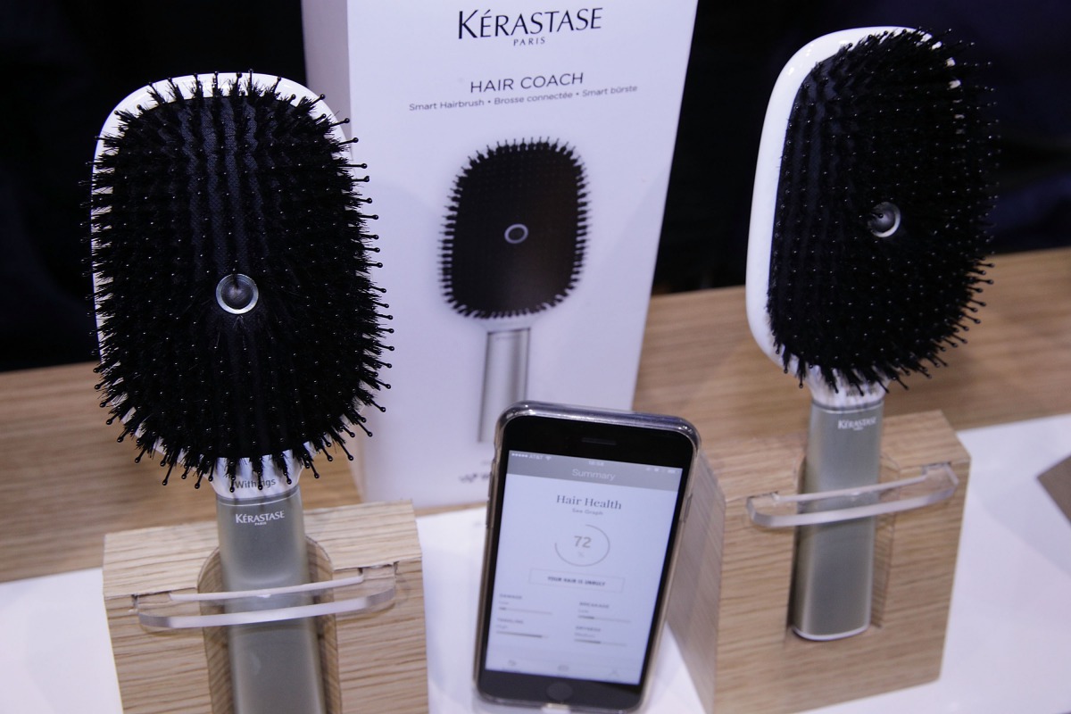 The Kerastase Hair Coach Powered by Withings, the world's first smart hairbrush developed in collaboration with L'Oreal's Research and Innovation Technology Incubator, with accompanying mobile app that helps people better care for their hair, seen during 