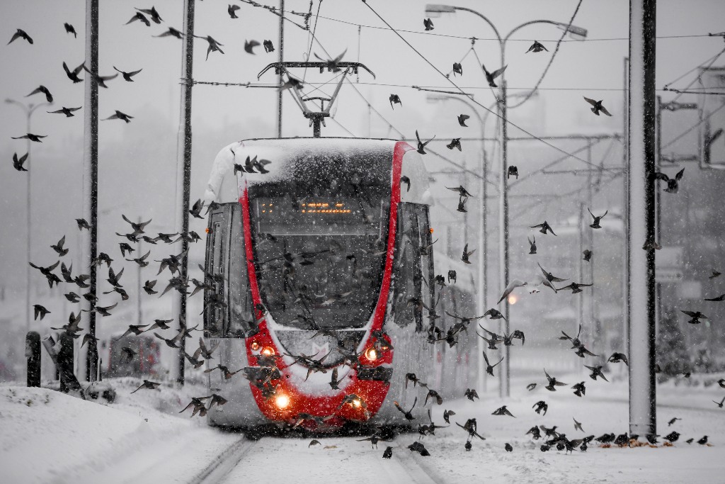 Seagulls fly as a tramway moves along the snow covered tramline during the heavy snowfall in Istanbul, Turkey on January 07, 2017. ( Arif Hüdaverdi Yaman - Anadolu Agency )
