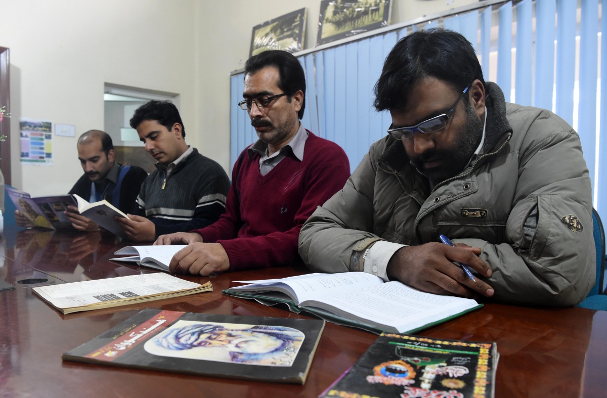 In this photograph taken on January 2, 2017, Pakistani men read Hindko language books at The Hindko Centre in Peshawar. Around a hundred women have gathered in a community centre in Peshawar, the heart of Pakistan's fabled northwest -- but they are conver