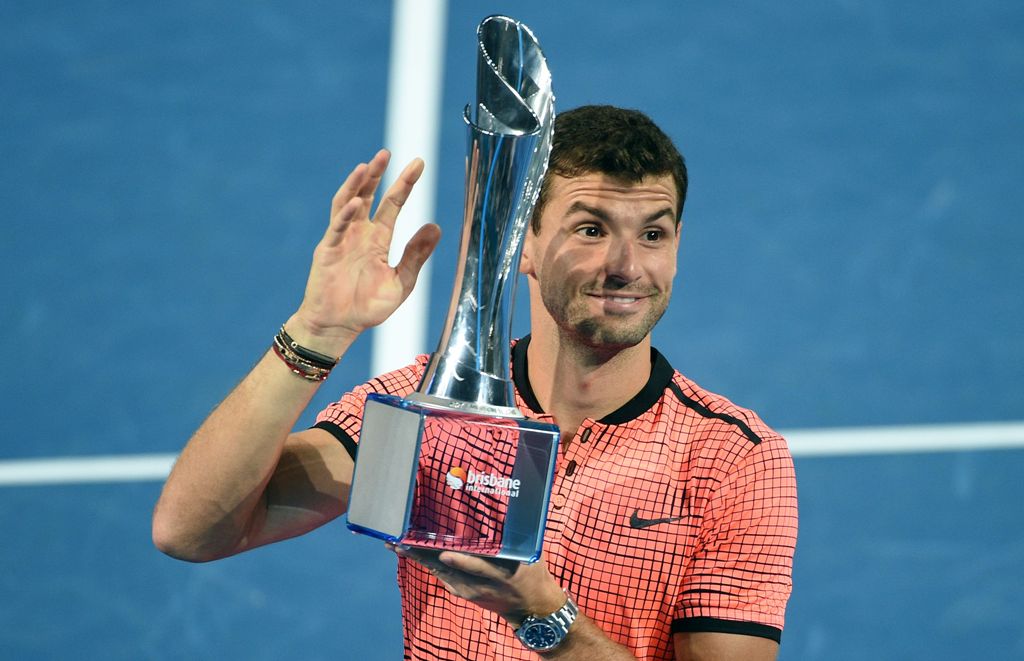 Grigor Dimitrov of Bulgaria lifts his winning trophy after defeating Kei Nishikori of Japan in their men's singles final at the Brisbane International tennis tournament in Brisbane on January 8, 2017.  AFP / SAEED KHAN