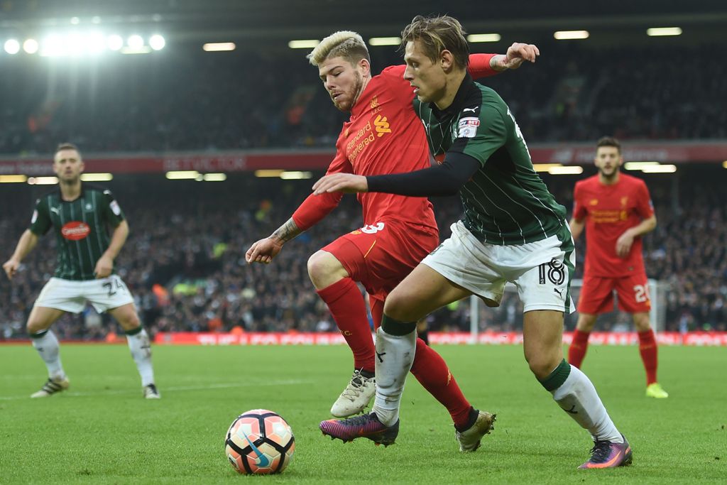 Plymouth's English midfielder Oscar Threlkeld vies with Liverpool's Spanish defender Alberto Moreno (2nd L) during the English FA Cup third round football match between Liverpool and Plymouth Argyle at Anfield in Liverpool, north west England on January 8