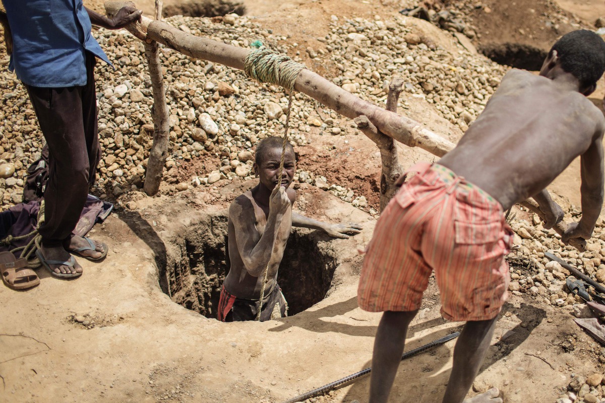 A malagasy Sapphire miner resurfaces from a hole in the ground during mining at an informal Sapphire mine on December 2, 2016 on the outskirts of Sakaraha, Madagascar. Sapphires were first discovered in Madagascar in the late 1990s, and already the Indian