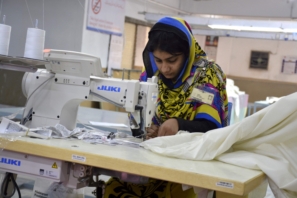In this photograph taken on November 16, 2016, a Pakistani machinist works at a textile factory in Faisalabad. As Pakistan slowly emerges from a long-term power crisis, its once booming textile sector is scrambling to find its feet -- but high energy cost