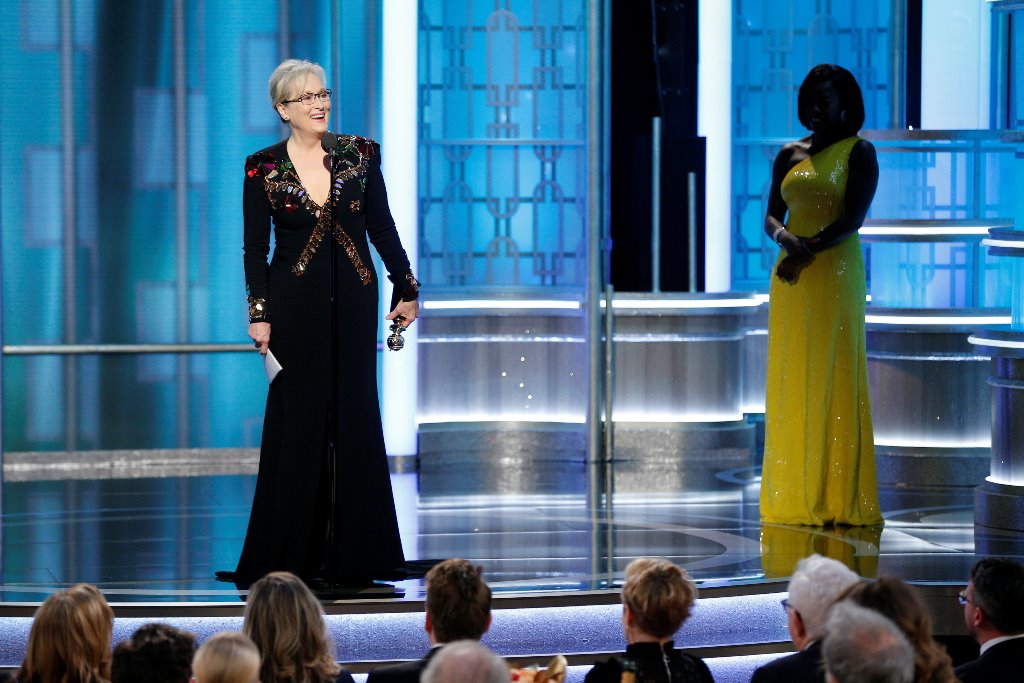 Actress Meryl Streep (L) accepts the Cecil B DeMille Award from presenter Viola Davis during the 74th Annual Golden Globe Awards show in Beverly Hills, California, U.S., January 8, 2017. Paul Drinkwater/Courtesy of NBC/Handout via REUTERS