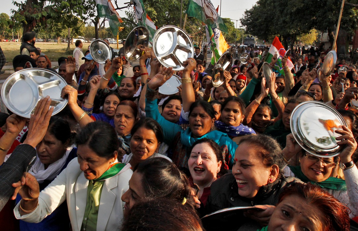 Women carrying kitchen utensils shout slogans during a protest organised by India's main opposition Congress party against demonetization in Chandigarh, India January 9, 2017. REUTERS/Ajay Verma