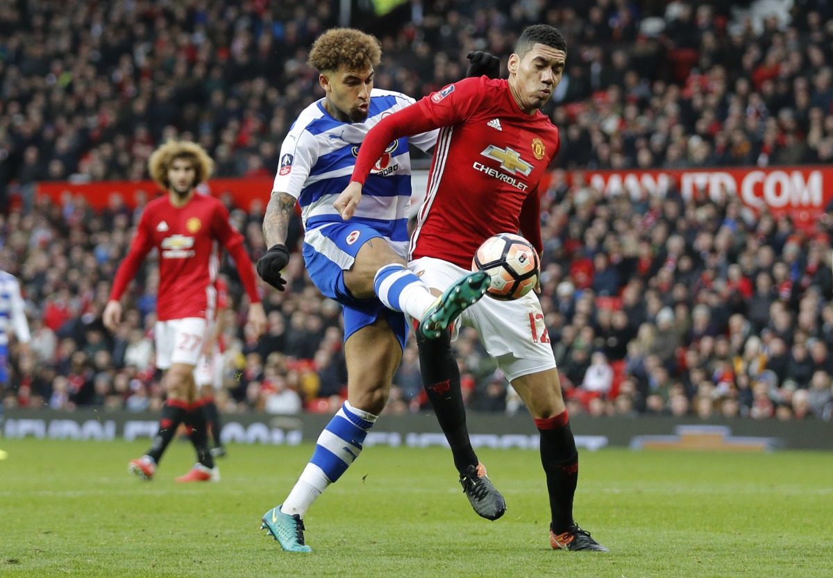 Manchester United's Chris Smalling in action with Reading's Daniel Williams. (Reuters / Darren Staples Livepic)