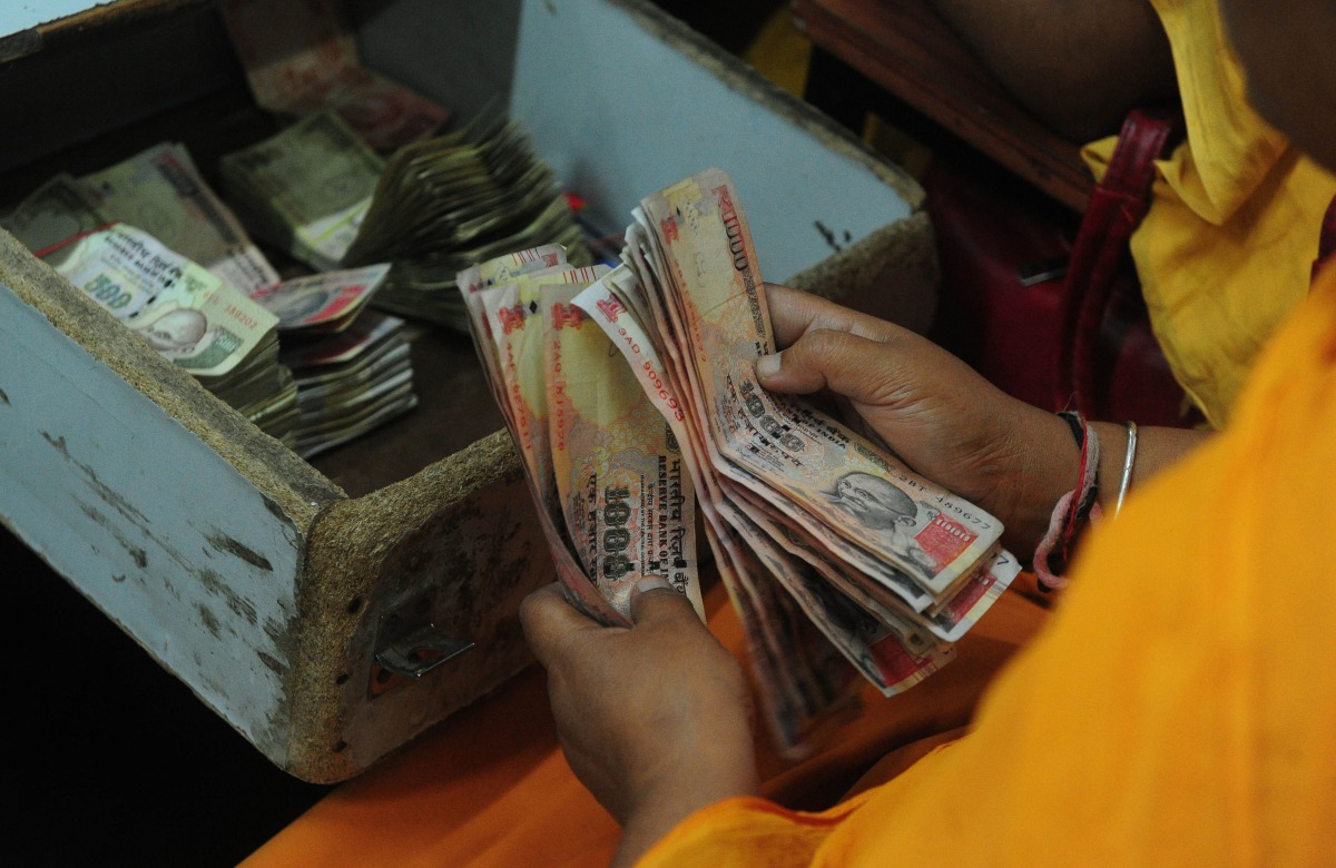 A person counting Indian currency notes (File Photo/ AFP)