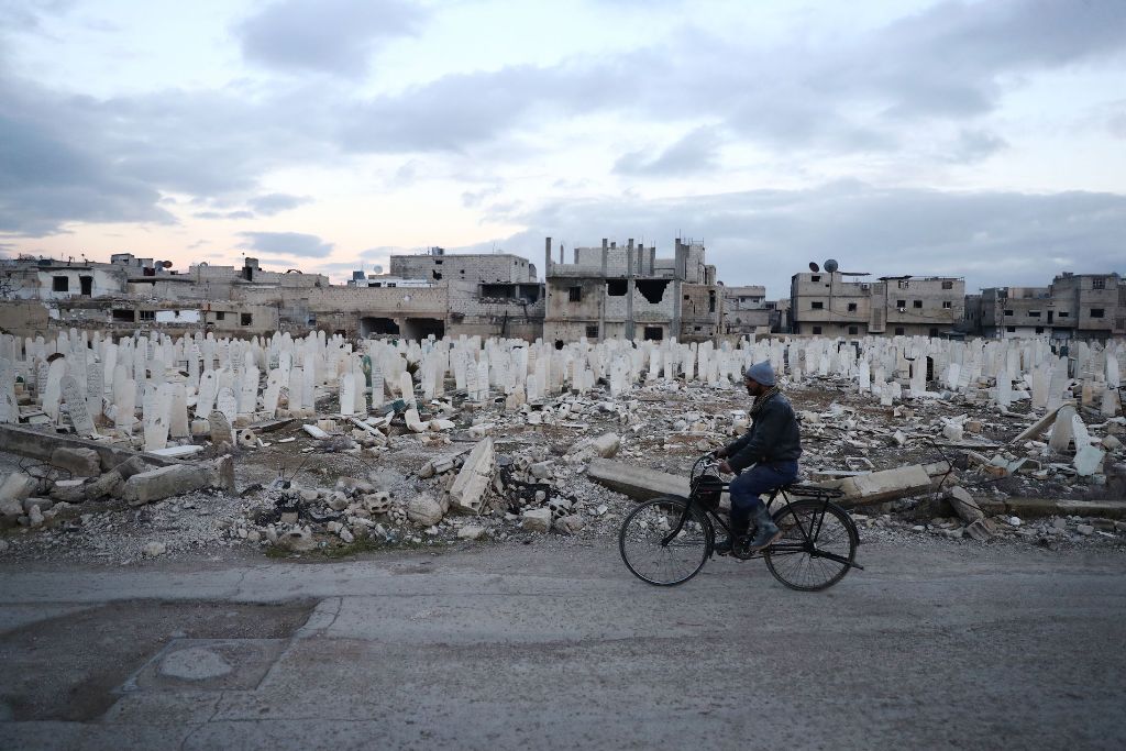A Syrian man rides a bicycle in the rebel-held town of Douma, on the eastern outskirts of the capital Damascus, on January 9, 2017. AFP / Abd Doumany
