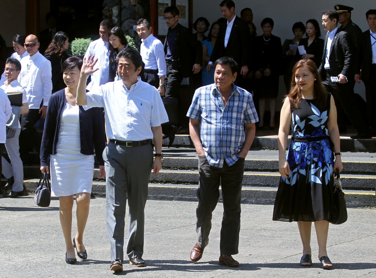 Japan's Prime Minister Shinzo Abe (2nd L), his wife, Akie Abe (L), Philippine President Rodrigo Duterte (2nd R), and his partner, Honeylet Avancena, walk towards the garden area of Waterfront Insular Hotel in Davao City, southern Philippines January 13, 2