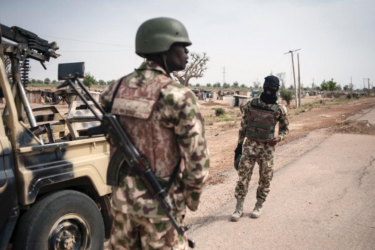 Soldiers of the 7th Division of the Nigerian Army stand by the road in Damboa Borno State northeast Nigeria on March 25, 2016 (AFP /STEFAN HEUNIS) 