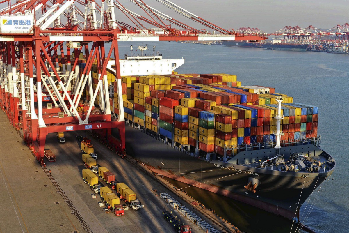 Container boxes are seen loaded in a vessl at a port in China.