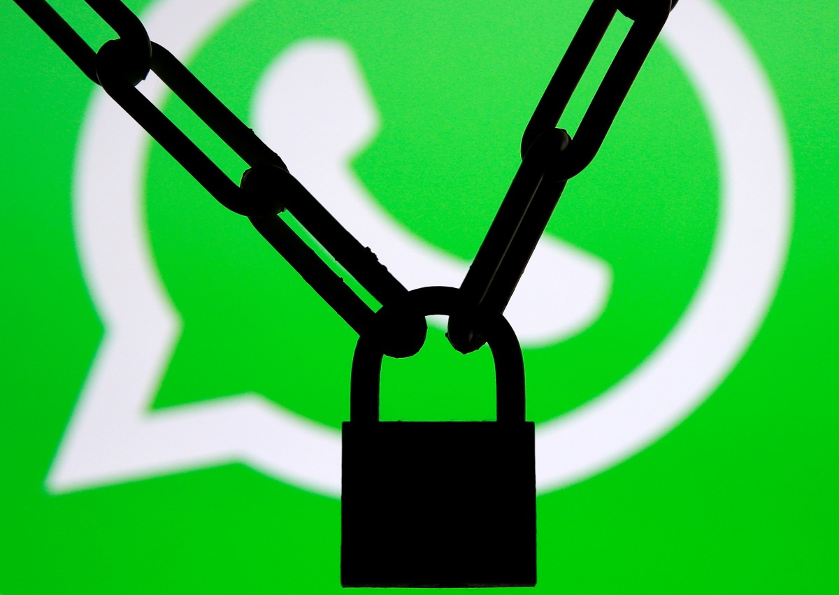 A photo illustration shows a chain and a padlock in front of a displayed Whatsapp logo January 13, 2017. (Reuters/Dado Ruvic/Illustration)