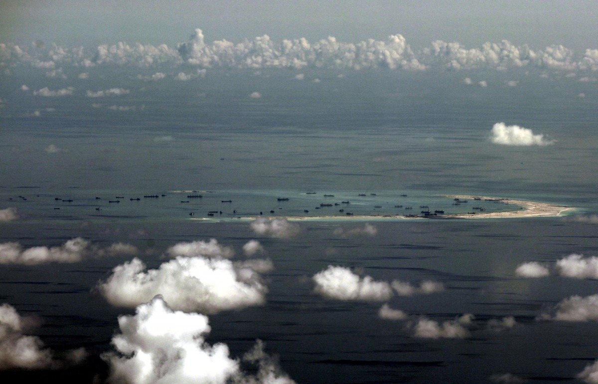  An aerial photo taken though a glass window of a Philippine military plane shows the alleged on-going land reclamation by China on mischief reef in the Spratly Islands in the South China Sea, west of Palawan, Philippines, May 11, 2015. REUTERS/Ritchie B.