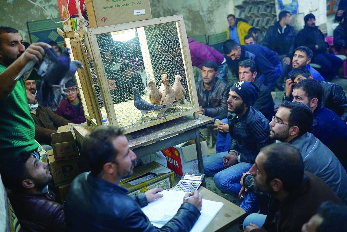 Auctioneer, Kadir Sakizci (left), at a pigeon auction in Sanliurfa, Turkey.