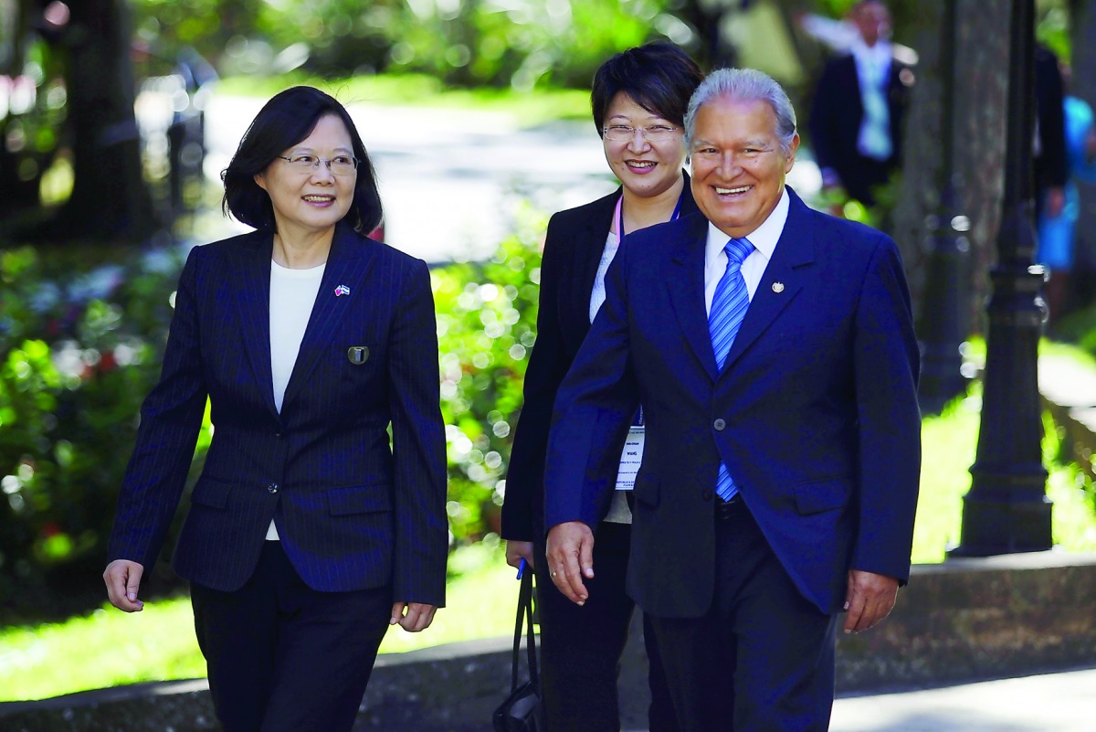 Taiwan's President Tsai Ing-wen (left) walks with El Salvador's President Salvador Sanchez Ceren before a decoration ceremony at the presidential house in San Salvador, El Salvador, yesterday.