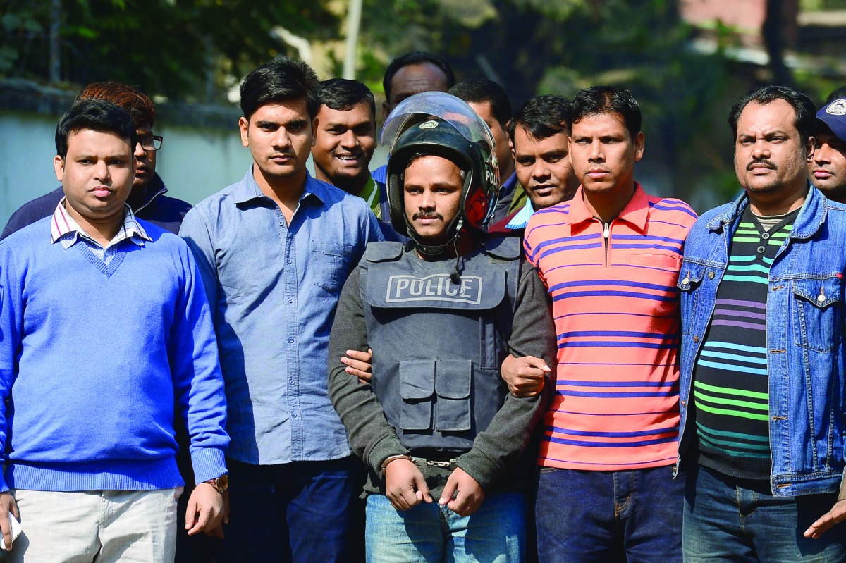 Bangladesh police escort alleged Islamist militant Jahangir Alam (C) in Dhaka on January 14, 2017, after his arrest in connection with an attack on the Holey Artisan Bakery attack last year. Bangladeshi police on January 14 said they arrested an Islamist 