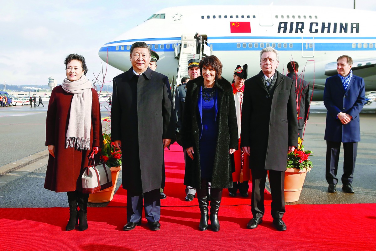 Chinese President Xi Jinping (second left) and his wife Peng Liyuan (left), Swiss President Doris Leuthard (second right) and her husband Roland Hausin listen to the national anthems during a welcome ceremony upon their arrival for a state visit to Switze