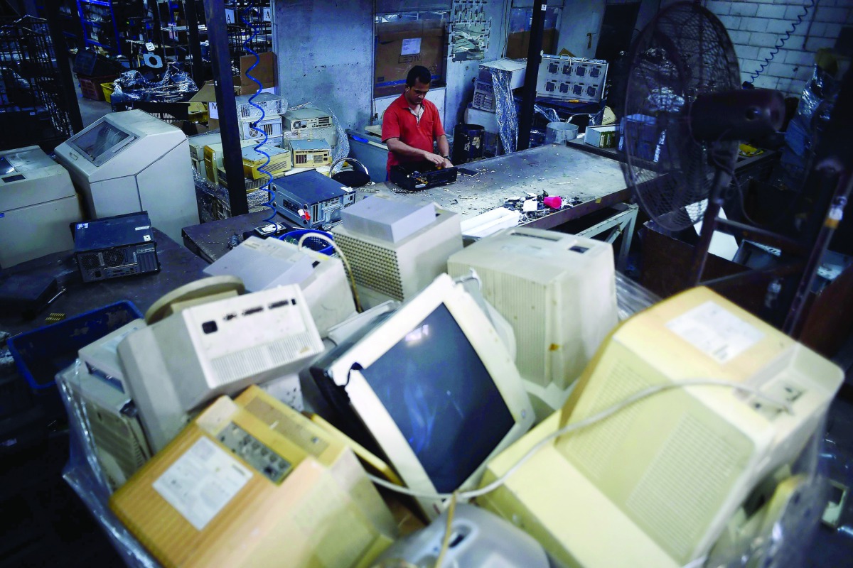 A worker sorting out electronic waste from discarded computer goods at Scrap Computing Trading (SCT) in Shah Alam on the outskirts of Kuala Lumpur. 