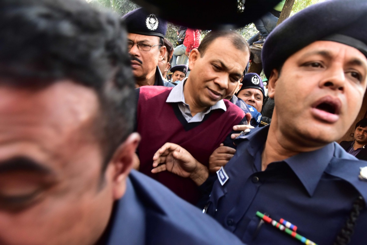 Bangladeshi Commander in the Rapid Action Battalion (RAB) Tarek Sayeed is escorted by police at Narayangong court in Narayangong on January 16, 2017. A Bangladesh court January 16 sentenced 26 people to death after hearing how a politician from the ruling
