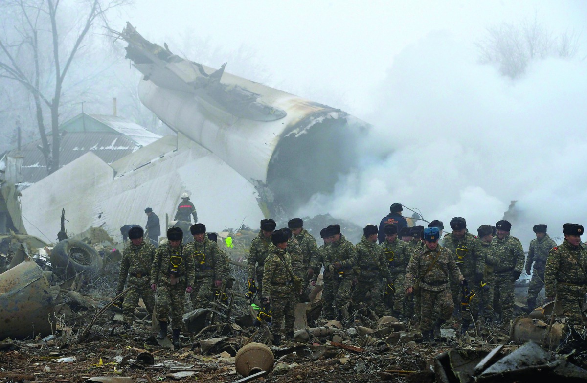 Rescue personnel work at the wreckage of a Turkish cargo plane after it crashed in the village of Dacha-Suu outside Bishkek, yesterday.