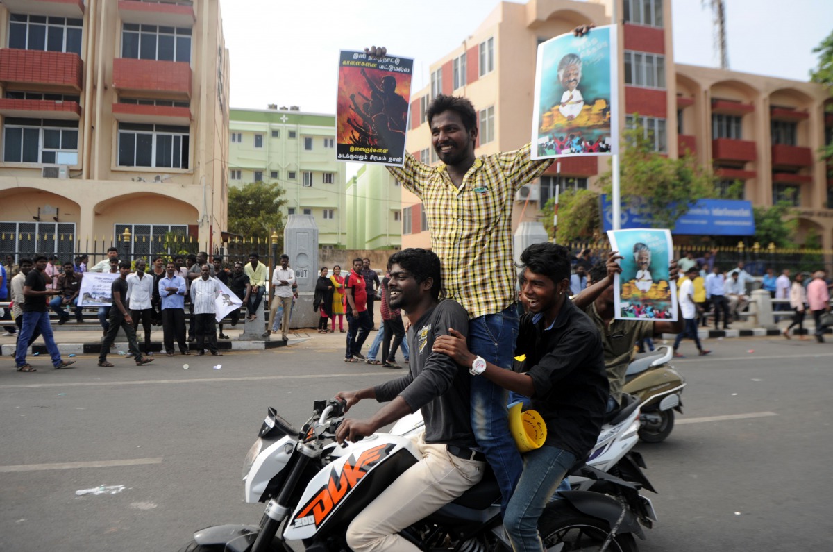 Indian students shout slogans and hold placards during a demonstration against the ban on the Jallikattu bull taming ritual, and calling for a ban on animal rights orgnisation PETA, at Marina Beach at Chennai on January 19, 2017. Prime Minister Narendra M