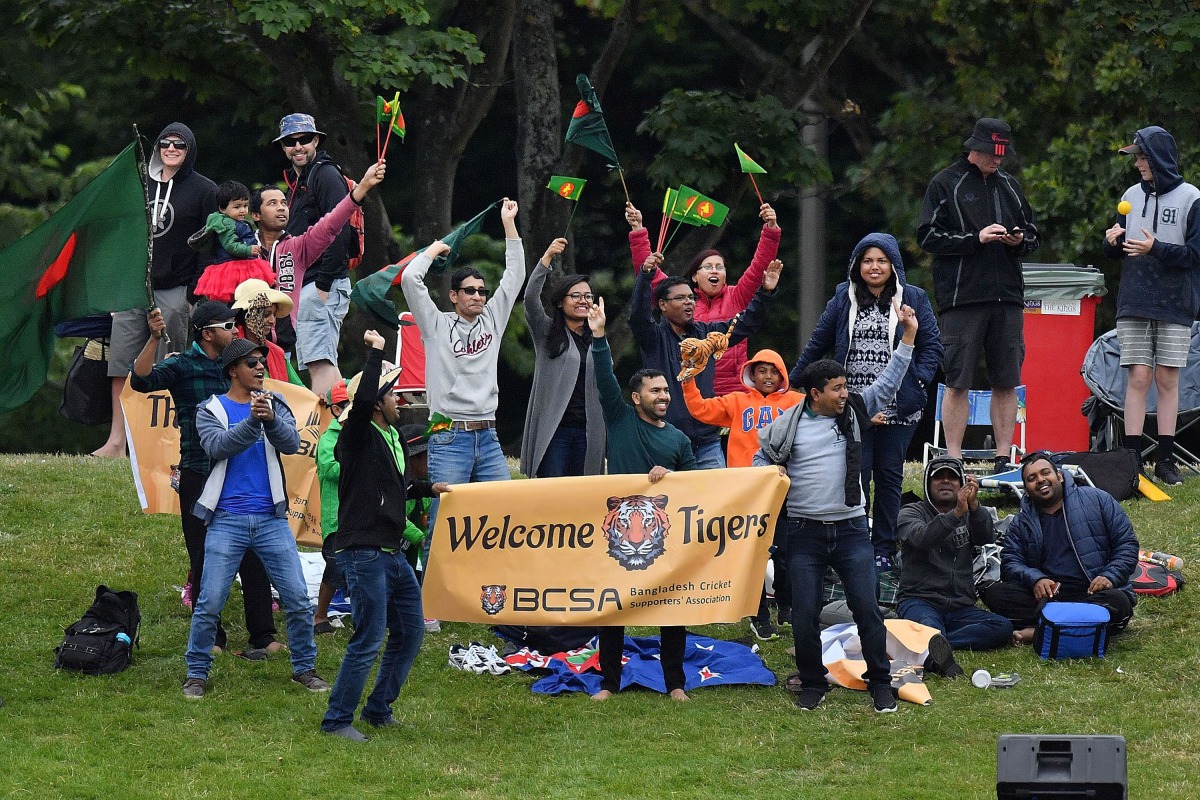 Bangladesh fans celebrate New Zealand's Mitchell Santner being caught with LBW during day two of the second international Test cricket match between New Zealand and Bangladesh at Hagley Park Oval in Christchurch on January 21, 2017. (AFP / Marty Melville)