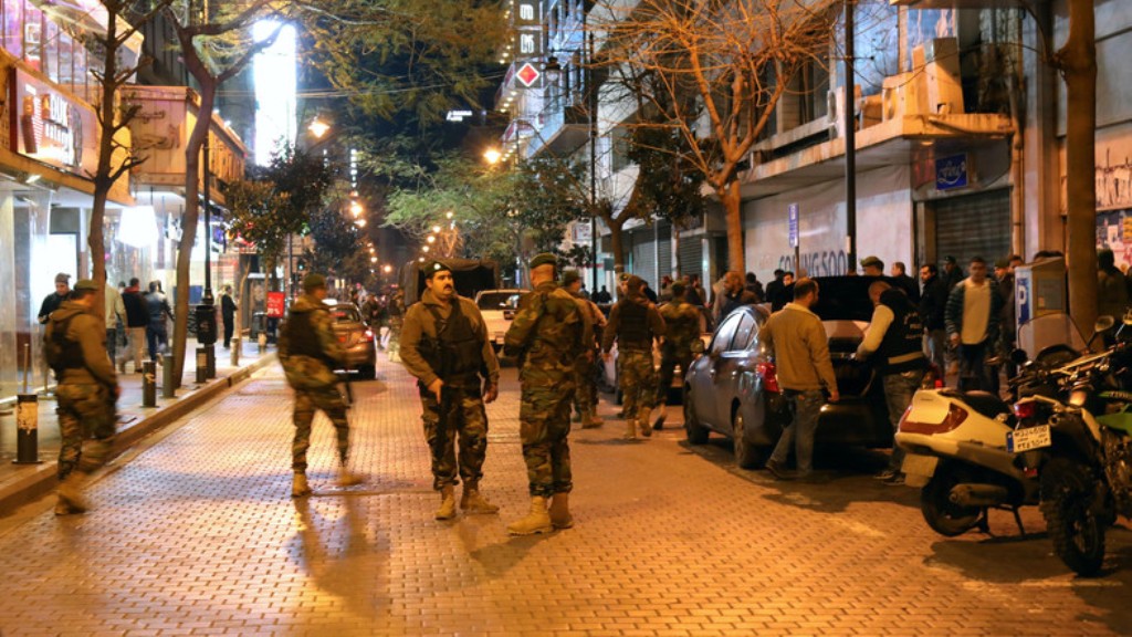 Lebanese security forces secure the street near the cafe in Hamra street in Beirut where a suicide bomber was arrested minutes before exploding himself on January 22, 2017. (AFP).