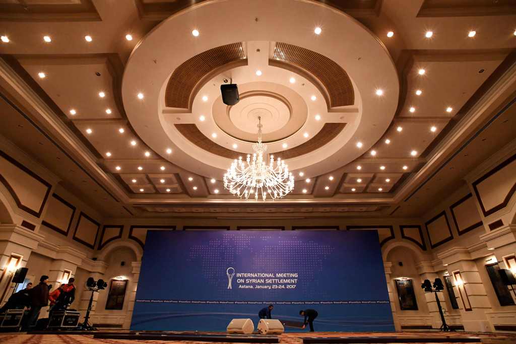 A picture taken on January 22, 2017 shows men at work to prepare the Syria peace talks conference room at Astana' Rixos President Hotel. The talks, set to begin on Monday, will be the first time a delegation composed exclusively of rebel groups will negot