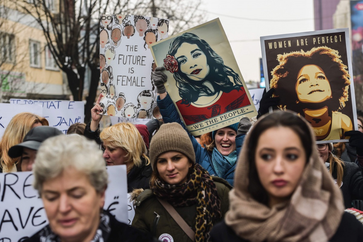 Women hold posters as they take part in a march for women's rights and freedom in solidarity with the march organised in Washington, on January 21, 2017 in Pristina. Hundreds of thousands of protesters spearheaded by women's rights groups are set to conve