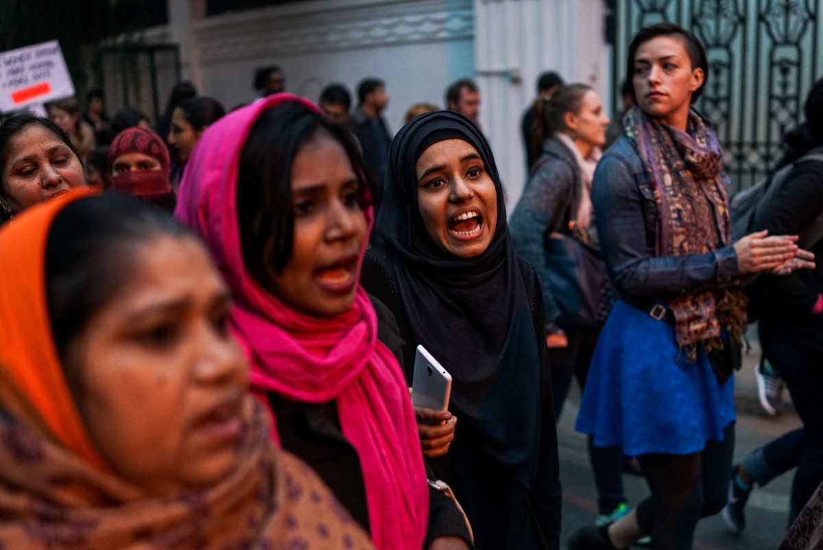Indian women shout slogans as they participate in a nationwide 