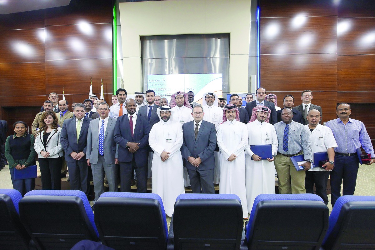 Officials of Oryx GTL pose for a group picture after the award ceremony at company's headquarters.