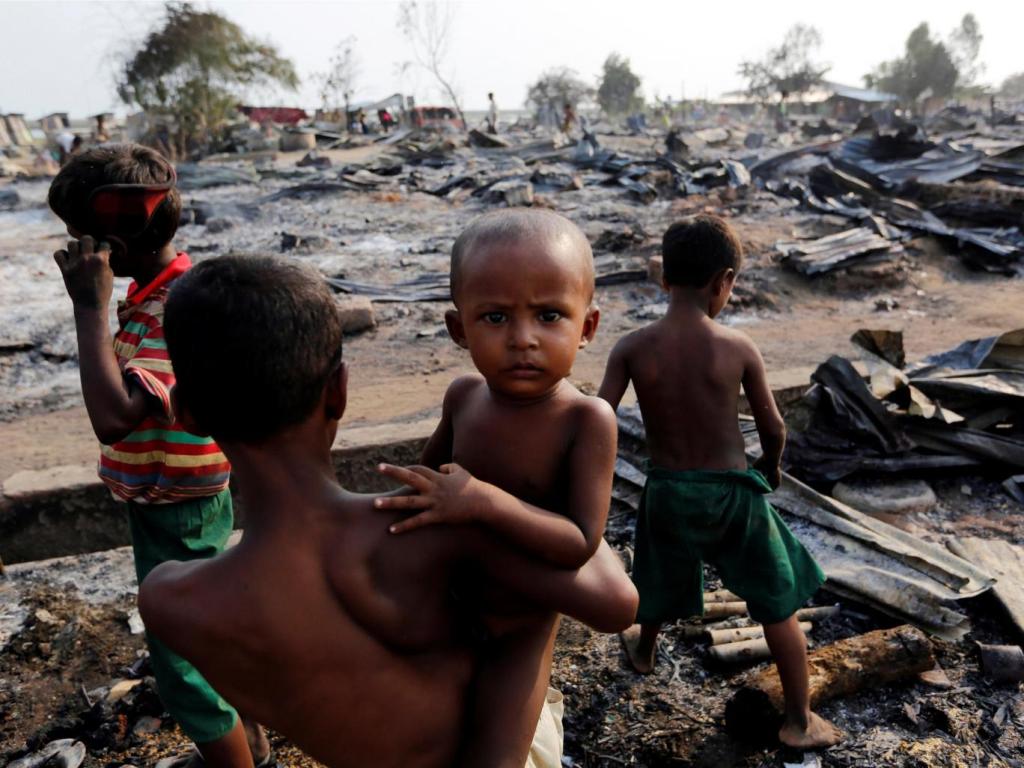 Boys stand among debris after fire destroyed shelters at a camp for internally displaced Rohingya Muslims in the western Rakhine State near Sittwe, Myanmar Reuters.