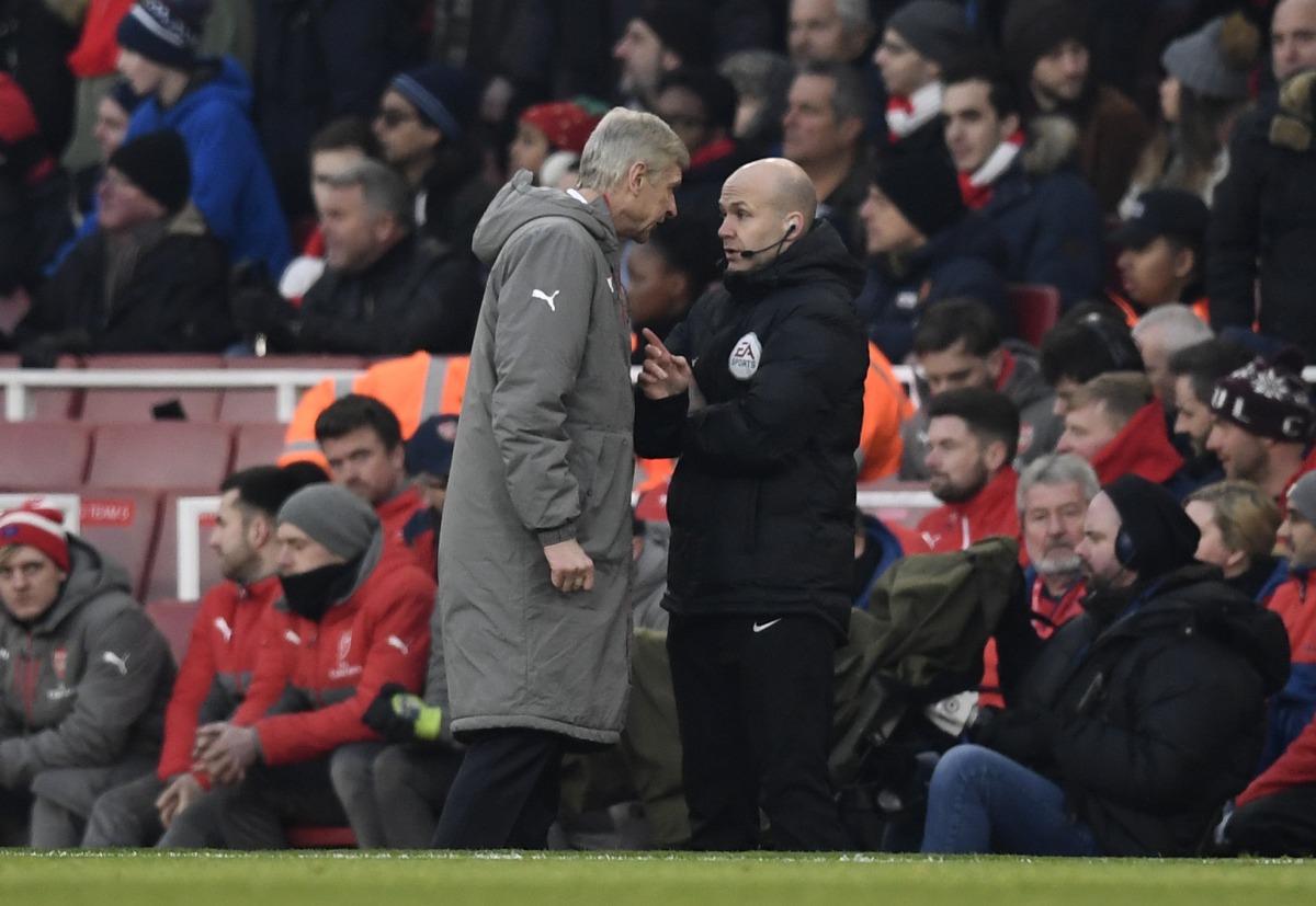 Arsenal manager Arsene Wenger clashes with fourth official Anthony Taylor before being sent to the stands. (Reuters / Dylan Martinez)