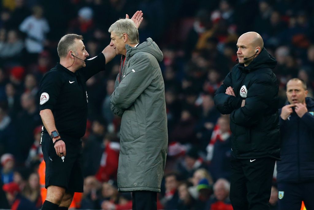 Arsenal's French manager Arsene Wenger (2nd L) is sent to the stands by English referee Jonathan Moss (L) as fourth official Anthony Taylor (R) looks on during the English Premier League football match between Arsenal and Burnley at the Emirates Stadium i