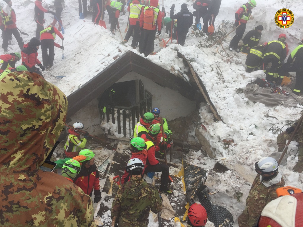 A handout picture released on January 23, 2017 by the Corpo Nazionale Soccorso Alpino e Speleologico (CNSAS) shows rescue teams working at the avalanche-hit Hotel Rigopiano, near the village of Farindola, on the eastern lower slopes of the Gran Sasso moun