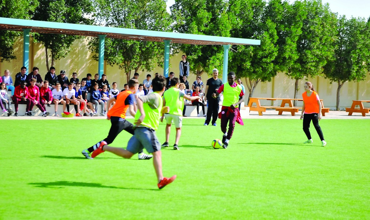 Eintracht Frankfurt Youth Academy player in action with the students during the German team's visit to German International School in Doha yesterday. Pic: Abdul Basit/The Peninsula
