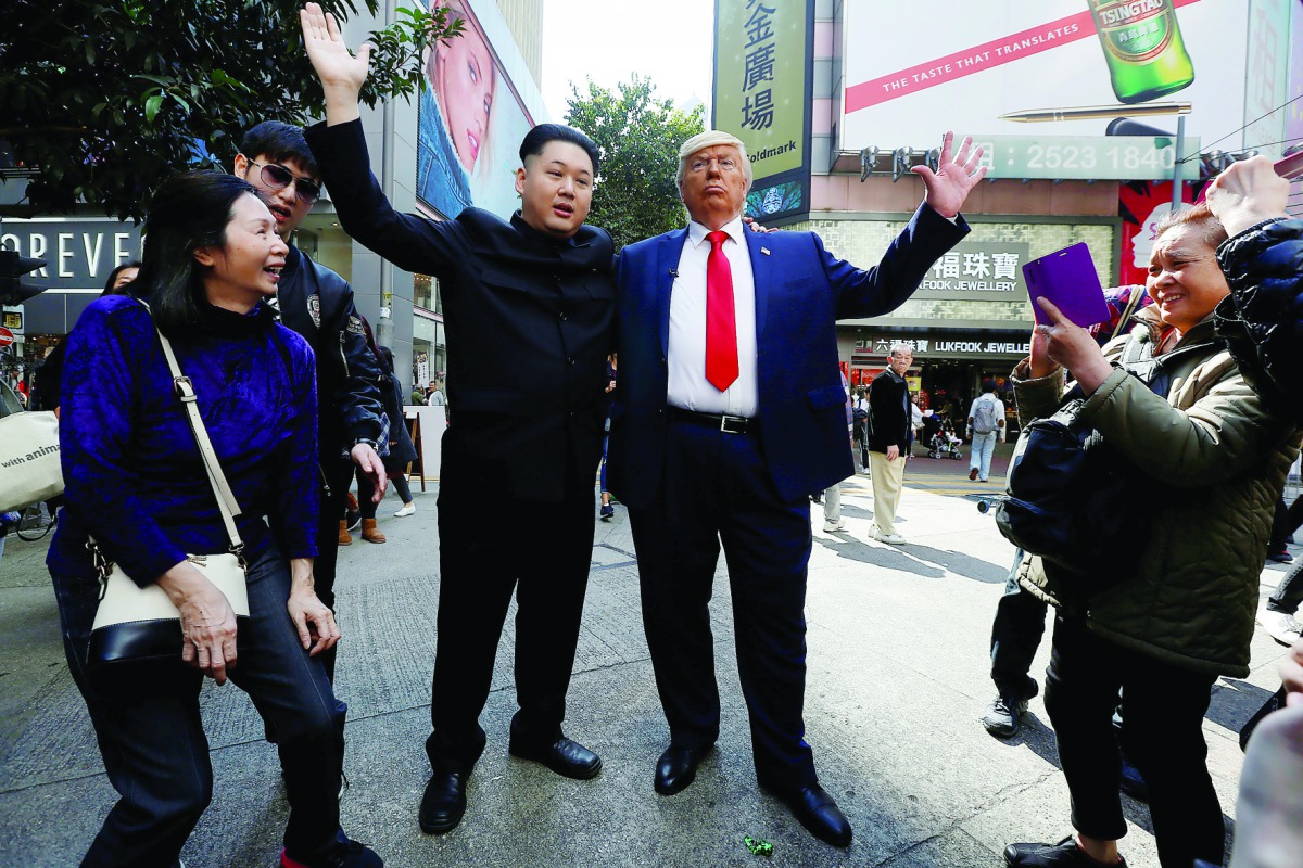 Howard, 37, an Australian-Chinese who is impersonating North Korean leader Kim Jong-un, and Dennis Alan of Chicago, 66, who is impersonating US President Donald Trump, pose on a street in Hong Kong, yesterday.