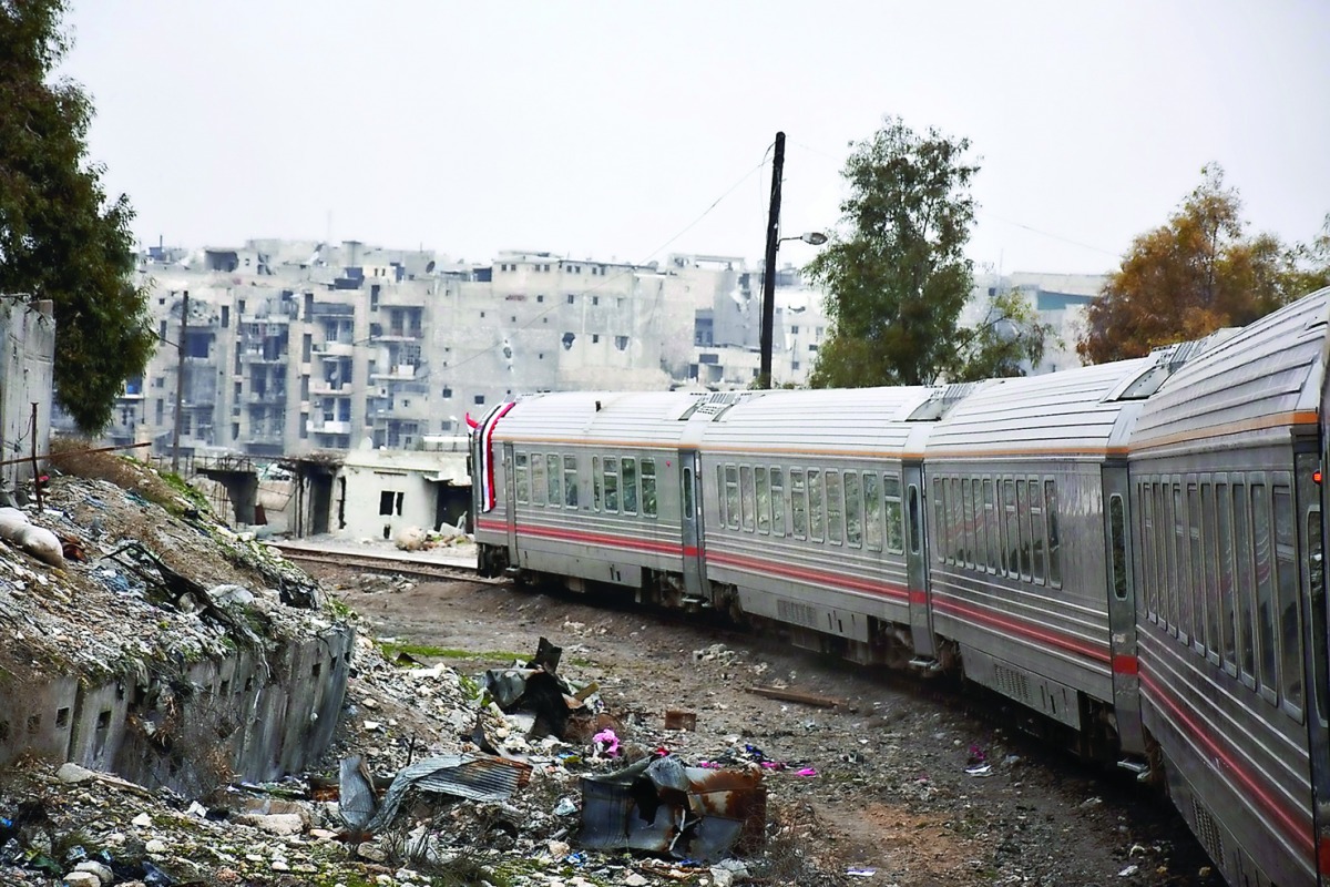 A train travels through Aleppo's devastated eastern districts for the first time in more than four years, yesterday. It is the train's first such trip since rebels overran east Aleppo in the summer of 2012, effectively dividing the northern city into a re