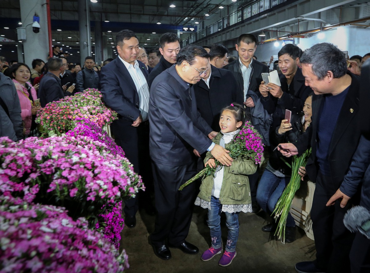 China's Premier Li Keqiang visits a flower market in Kunming, Yunnan province, China January 24, 2017. China Daily via REUTERS