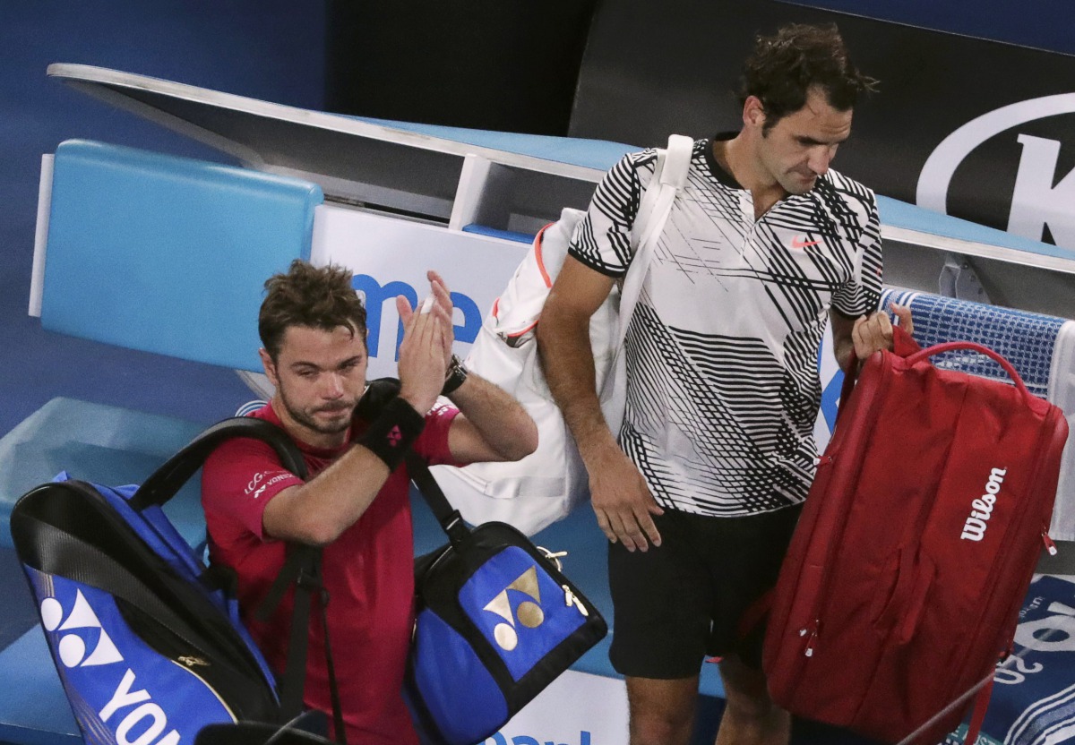 Switzerland's Stan Wawrinka applauds next to Switzerland's Roger Federer as they leave the court after their Men's singles semi-final match. (REUTERS/Jason Reed)
