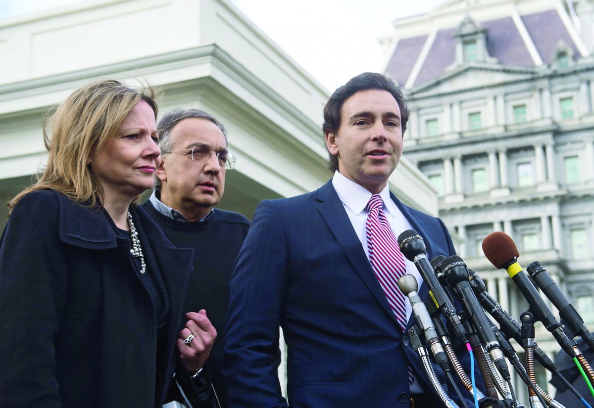 Ford CEO Mark Fields (R) speaks to the press with Fiat-Chrysler CEO Sergio Marchionne (C) and General Motors CEO Mary Barra following a meeting of automakers with US President Donald Trump at the White House in Washingon, DC, on January 24, 2017. / AFP / 