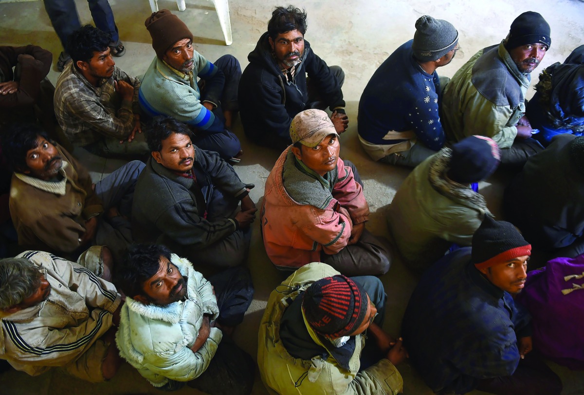 Arrested Indian fishermen sit at a police station in Karachi, yesterday.