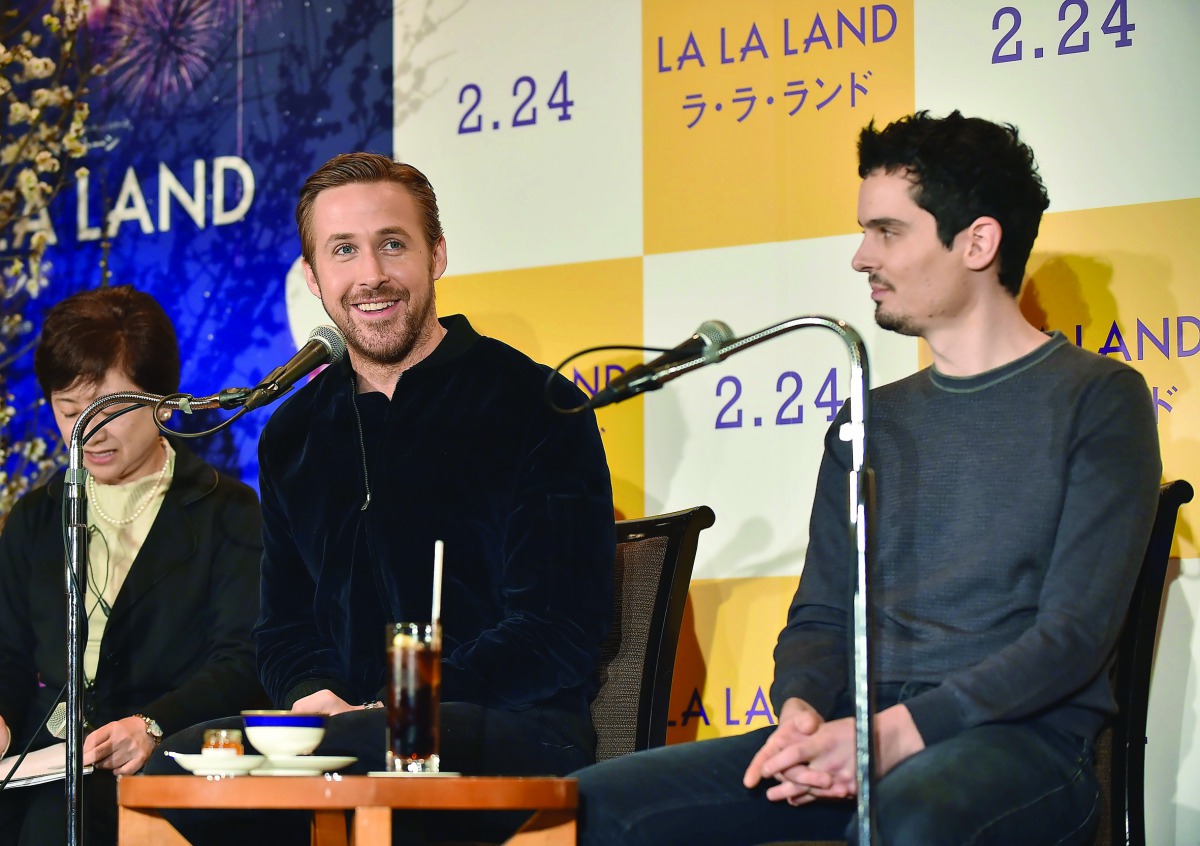 Canadian actor Ryan Gosling (centre) answers questions as US director Damien Chazelle looks on during a press conference for their film 'La La Land' in Tokyo, yesterday.